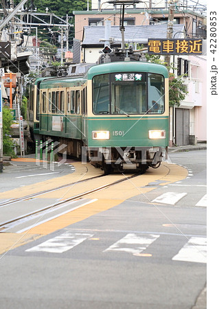 腰越駅を出発して路面走行に入る江ノ電（電車接近表示、車なし） 42280853