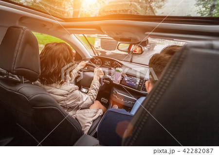 woman driving a car in a sunny day 42282087
