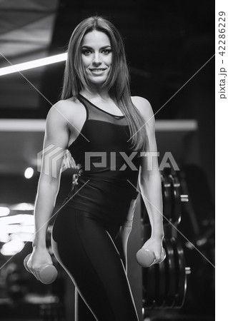 Beautiful sexy athletic girl working out in gym Beautiful sexy athletic girl working out in gym 42286229