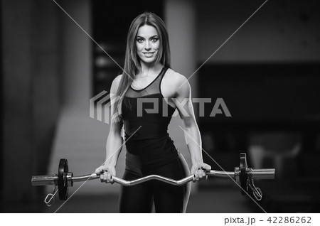 Beautiful sexy athletic girl working out in gym Beautiful sexy athletic girl working out in gym 42286262