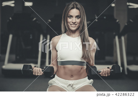 Beautiful sexy athletic girl working out in gym 42286322