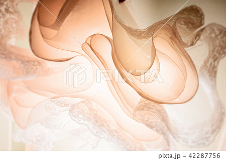 Delicate detail of a wedding dress. Fine lace texture. 42287756