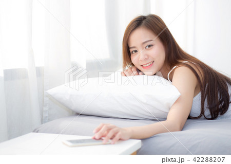 Beautiful asian woman hand of turn off alarm phone Beautiful asian woman hand of turn off alarm phone 42288207
