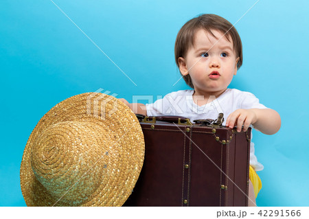 Toddler boy travel theme with a suitecase and a hat Toddler boy travel theme with a suitecase and a hat 42291566