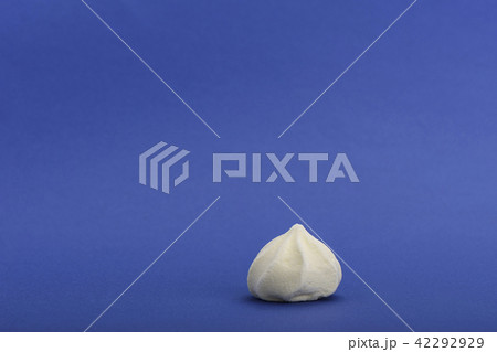 Yellow meringue isolated on blue background Yellow meringue isolated on blue background 42292929