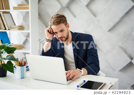 Thoughtful male working in business center 42294923