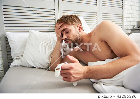 Exhausted man waking up at home 42295536