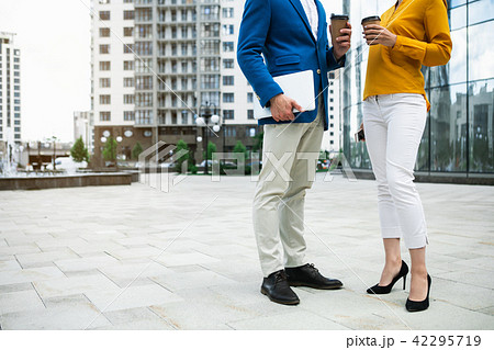 Successful businesspeople drinking hot beverage outdoor Successful businesspeople drinking hot beverage outdoor 42295719