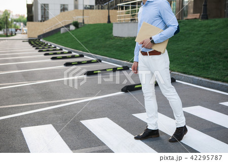 Man in formalwear walking on road Man in formalwear walking on road 42295787