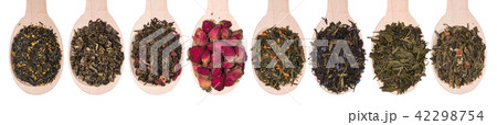 Set of different dry herbal teas in wooden spoons isolated on a white Set of different dry herbal teas in wooden spoons isolated on a white 42298754