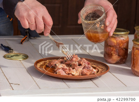 man puts the stew on a plate 42299700