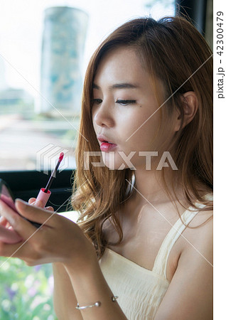 Woman with makeup brushes face. Asian beauty. Woman with makeup brushes face. Asian beauty. 42300479