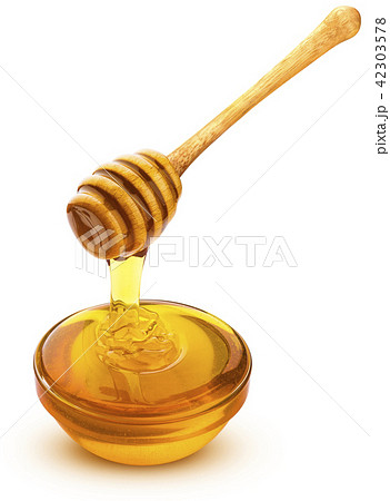 Honey dipper and bowl of pouring honey isolated on white background 42303578