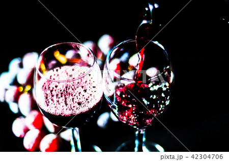 pouring red wine in a glass pouring red wine in a glass 42304706