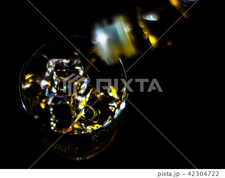 pouring single malt whisky into a glass pouring single malt whisky into a glass 42304722