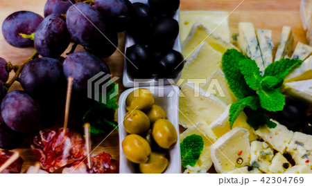 set of different cheeses on a wooden board 42304769