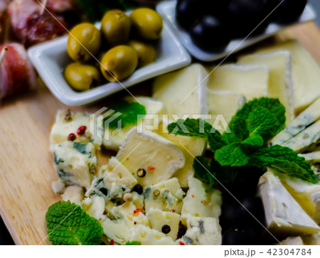 set of different cheeses on a wooden board 42304784