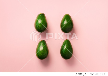 Green avocado pattern on pink background. Top view 42309823