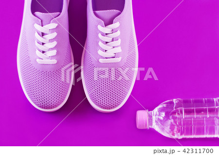 Violet sneakers on a purple background. 42311700