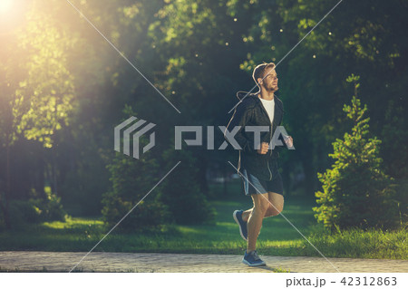 Young sportsman warming up in morning  42312863