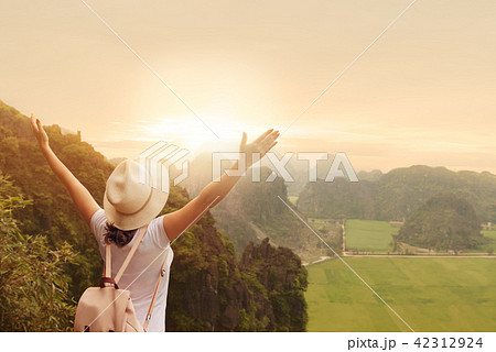 woman tourist  enjoying valley view with sunset 42312924