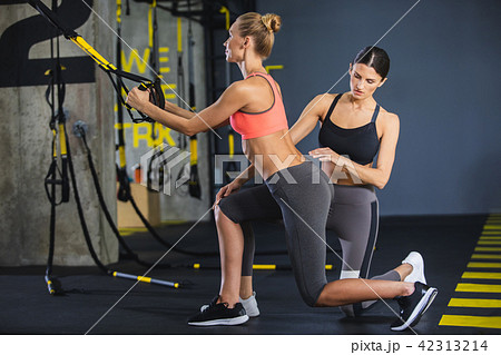 Female instructor is training sporty girl in gym 42313214