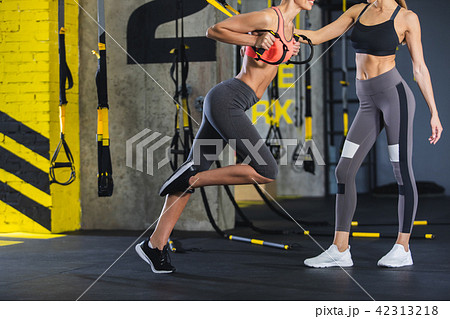 Female instructor is holding crossfit for girl Female instructor is holding crossfit for girl 42313218