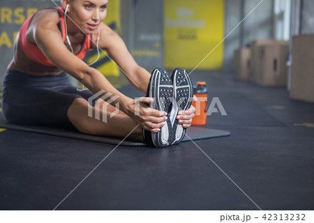 Slim woman is stretching in fitness room 42313232