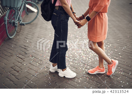 Women keeping each other arms Women keeping each other arms 42313524