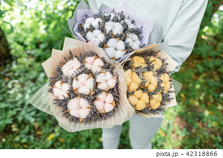 three beautiful and different bouquets lavender with cotton in woman hands . dried flowers lilac 42318866