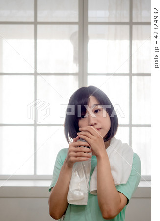 Woman drinking water after exercise 42324932