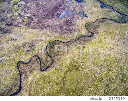 Aerial view of the river next to the B4391 through the moor and mountains of Wales, United Kingdom Aerial view of the river next to the B4391 through the moor and mountains of Wales, United Kingdom 42325339