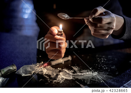 Male Junkie preparing heroin dose. Drug addiction Male Junkie preparing heroin dose. Drug addiction 42328665