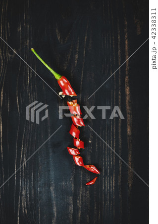 Red hot chilli pepper on black wood, top view 42338311