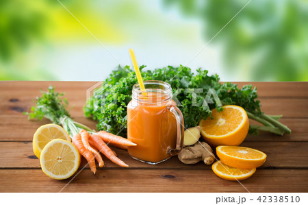 glass jug of carrot juice, fruits and vegetables glass jug of carrot juice, fruits and vegetables 42338510