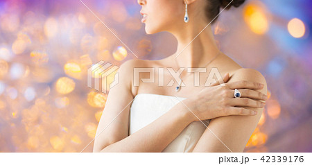 close up of beautiful woman with finger ring 42339176