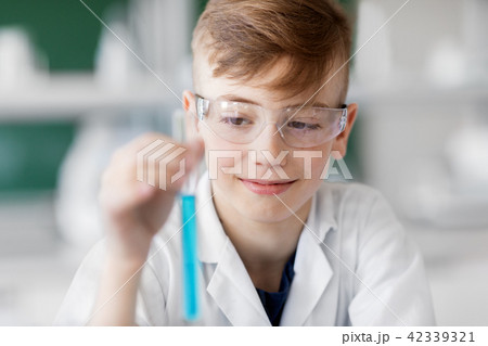 boy with test tube studying chemistry at school boy with test tube studying chemistry at school 42339321
