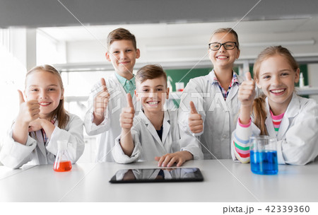happy kids showing thumbs up at school laboratory 42339360