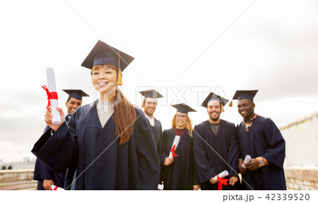 happy students in mortar boards with diplomas happy students in mortar boards with diplomas 42339520