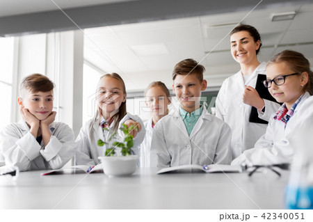 students and teacher with plant at biology class students and teacher with plant at biology class 42340051