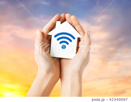 hands holding house with radio wave signal icon hands holding house with radio wave signal icon 42340097