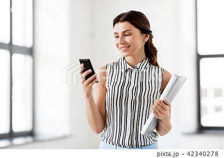 businesswoman with smartphone and folder at office 42340278