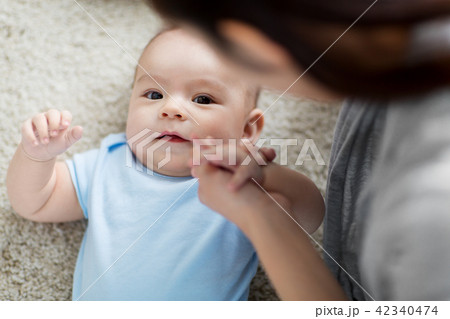 close up of sweet little asian baby boy and mother close up of sweet little asian baby boy and mother 42340474
