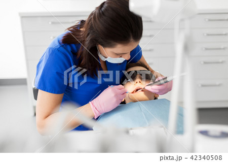 dentist checking for kid teeth at dental clinic dentist checking for kid teeth at dental clinic 42340508