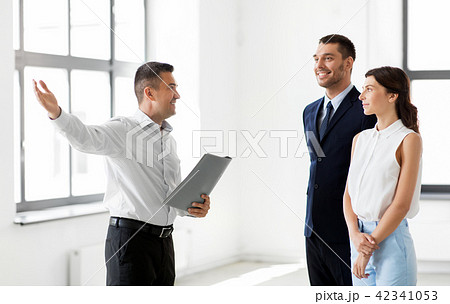 realtor with folder showing customers new office realtor with folder showing customers new office 42341053