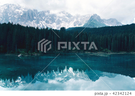 The Karersee lake with reflection of mountains in the Dolomites. The Karersee lake with reflection of mountains in the Dolomites. 42342124
