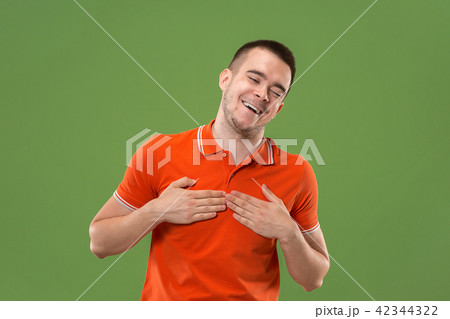 Beautiful male half-length portrait isolated on green studio backgroud. The young emotional Beautiful male half-length portrait isolated on green studio backgroud. The young emotional 42344322