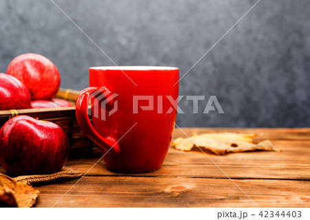Fall harvest cornucopia. Cup of Hot apple tea  42344403
