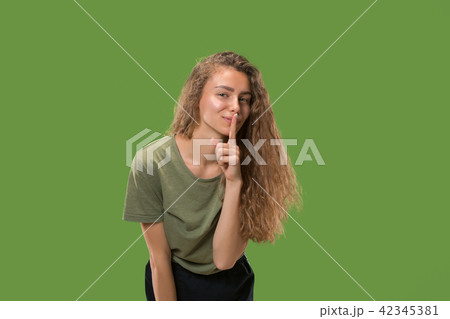 The young woman whispering a secret behind her hand The young woman whispering a secret behind her hand 42345381
