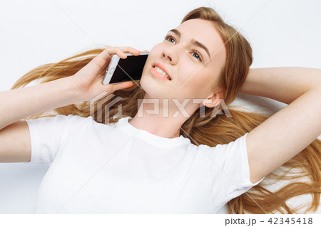 Beautiful young girl talking on the phone Beautiful young girl talking on the phone 42345418